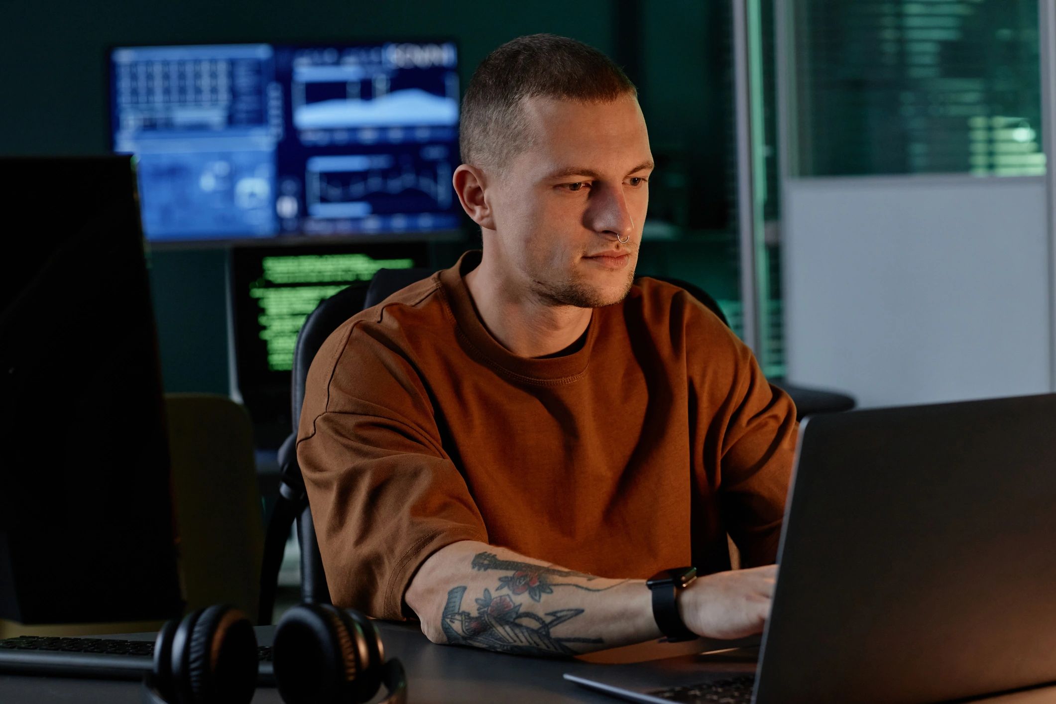 Technology professional working at a laptop in an office